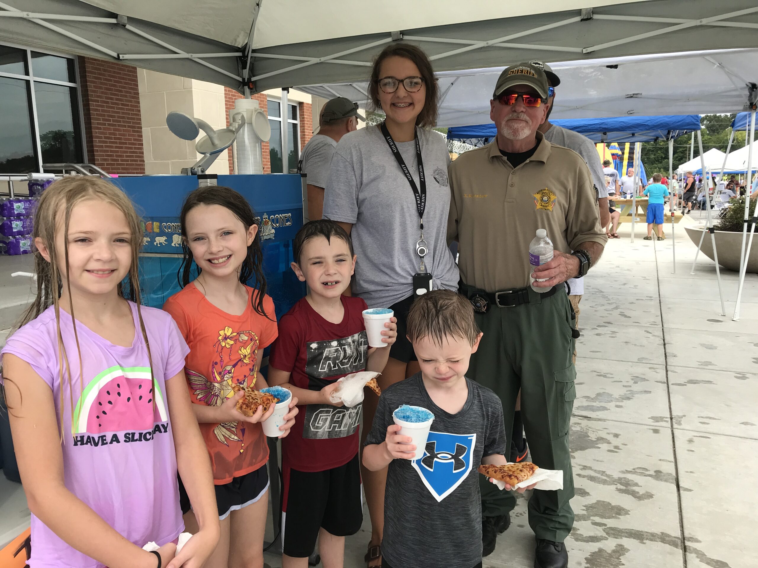 Emma enjoying pizza & snow cones with kids