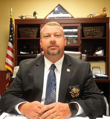 Sheriff Tommy Jones at desk